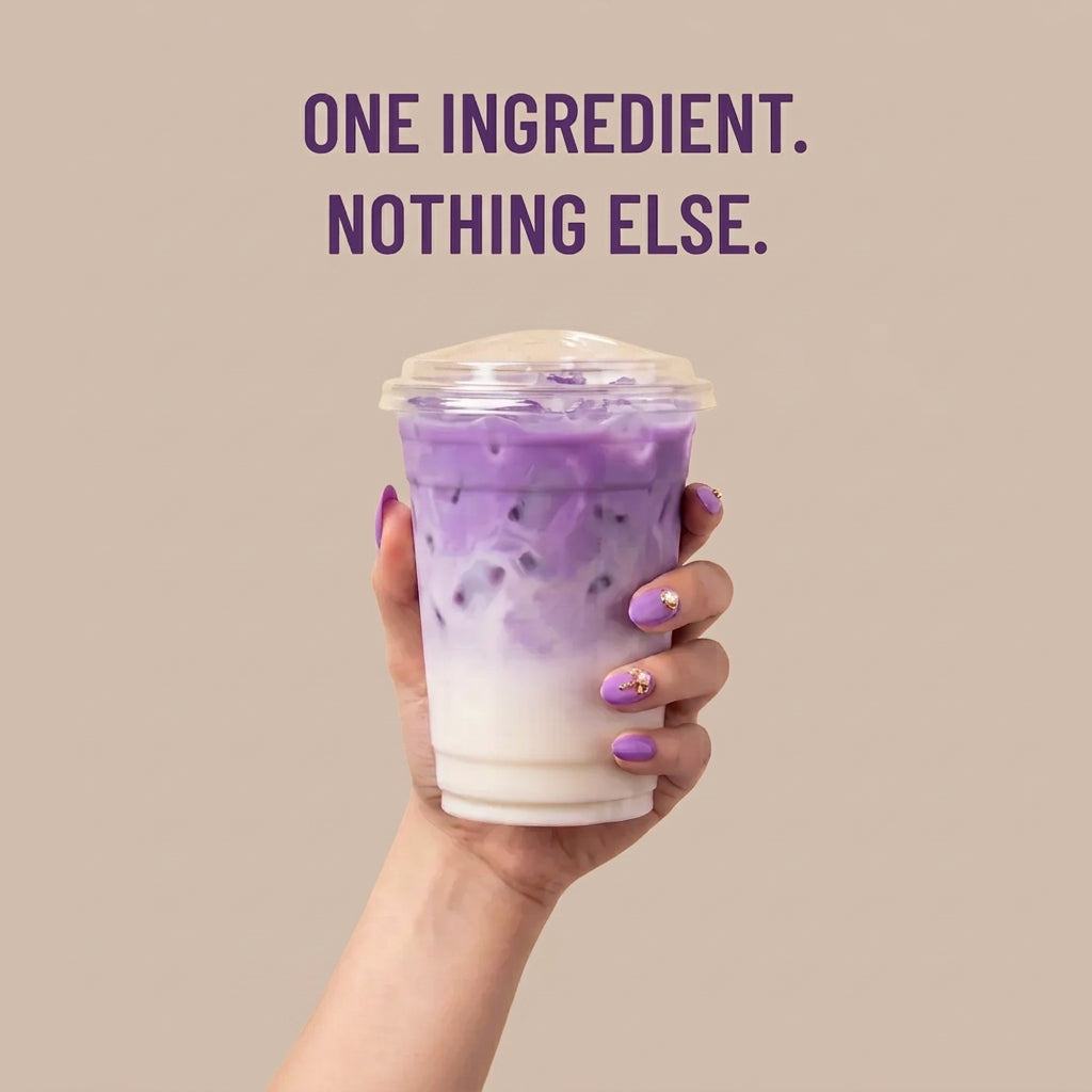 Hand holding an iced ube latte